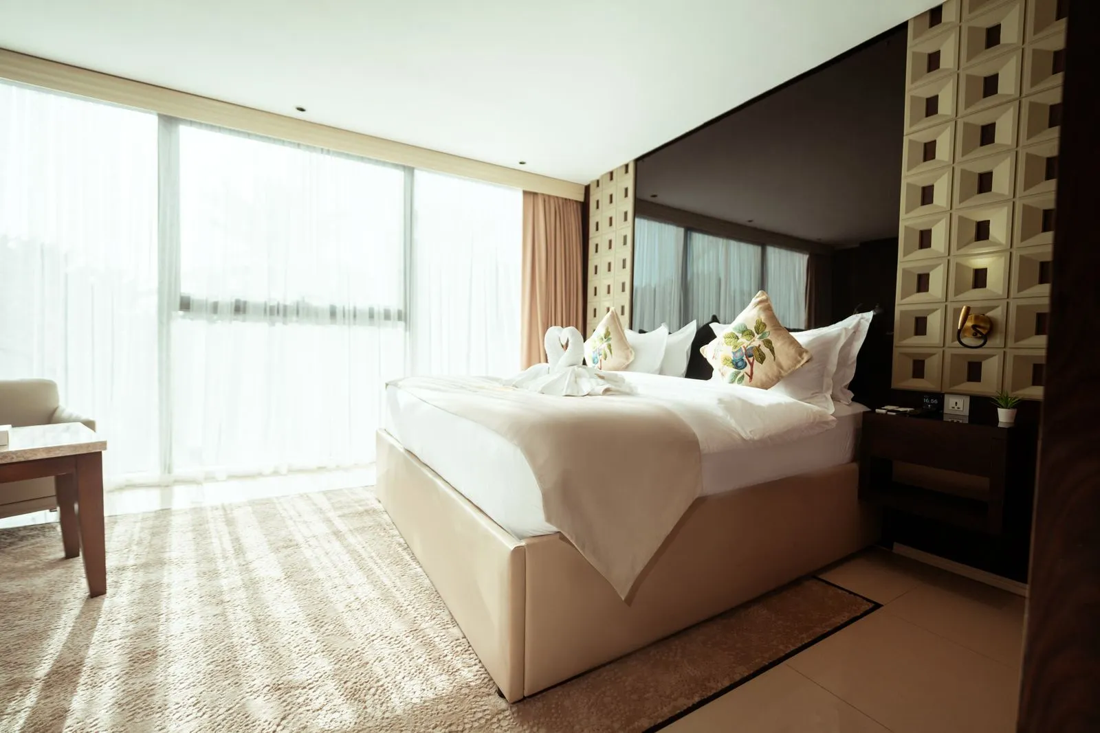 Luxurious hotel room in Baghdad with modern decor and natural light.